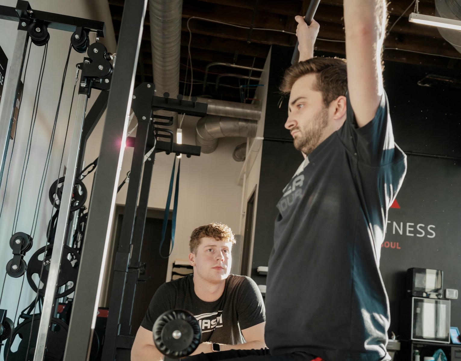 a man holding a barbell in a gym